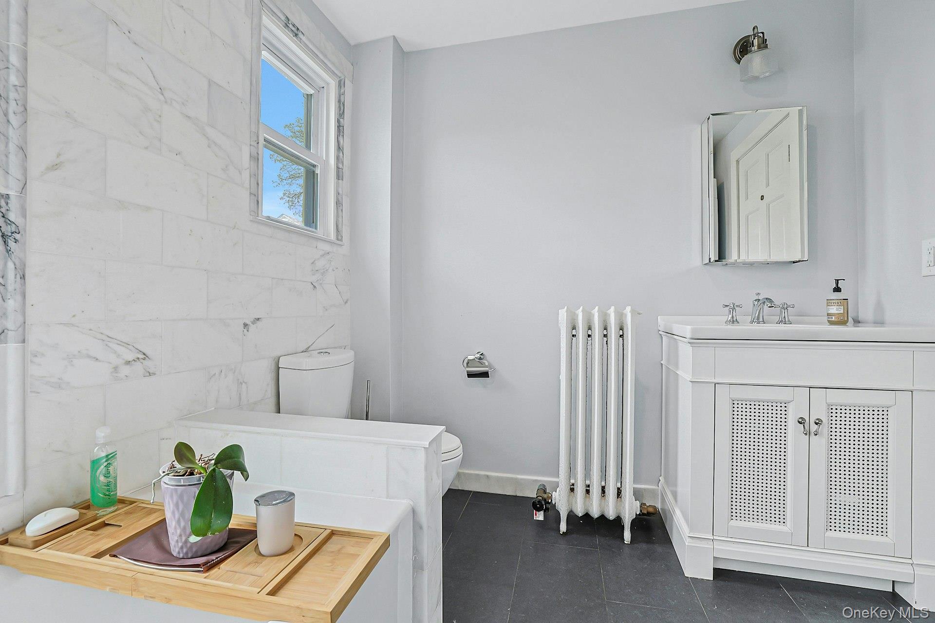 41 Clinton Avenue Ossining, NY 10562 - Photo 31 of 44 a bathroom with a sink a mirror and vanity