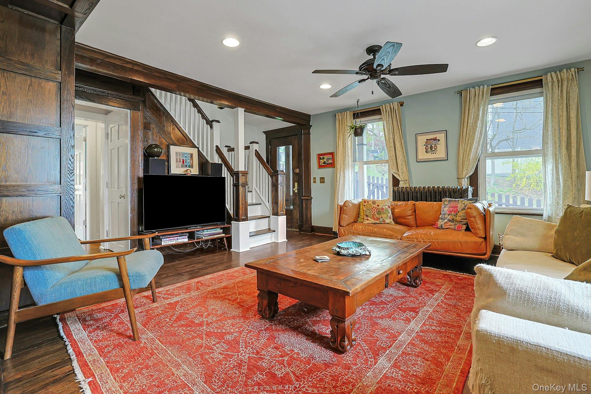 41 Clinton Avenue Ossining, NY 10562 - Photo 7 of 44 a living room with furniture a flat screen tv and a large window