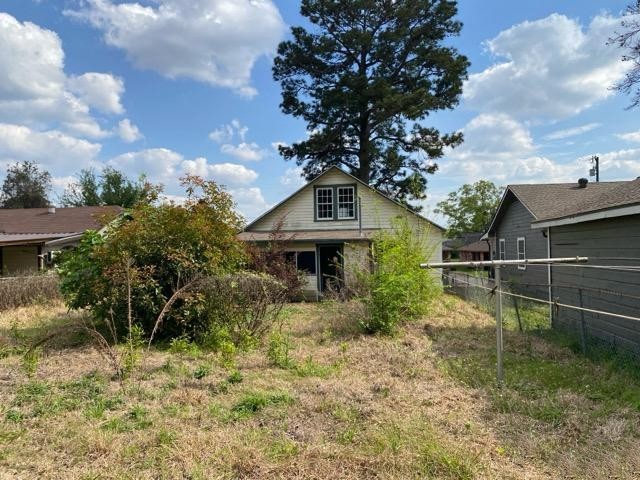 1004 Mccall Avenue Conroe, TX 77301 - Photo 14 of 14 a view of a house with a yard