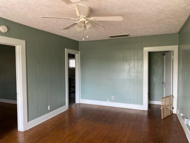 1004 Mccall Avenue Conroe, TX 77301 - Photo 4 of 14 an empty room with wooden floor closet and windows
