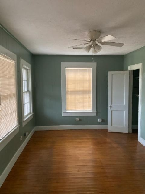 1004 Mccall Avenue Conroe, TX 77301 - Photo 5 of 14 an empty room with wooden floor and windows