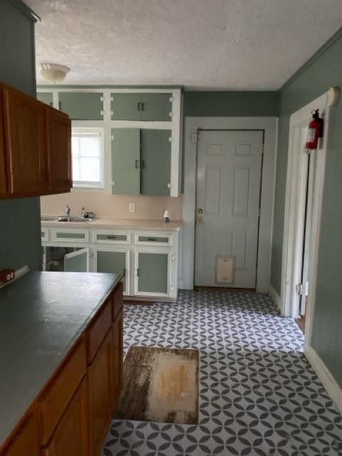1004 Mccall Avenue Conroe, TX 77301 - Photo 9 of 14 a kitchen with a sink a stove a refrigerator and cabinets
