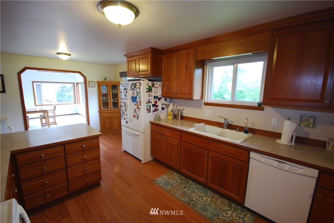 10404 Southeast 166th Street Renton, WA 98055 - Photo 11 of 29 a kitchen with stainless steel appliances granite countertop a sink stove and cabinets