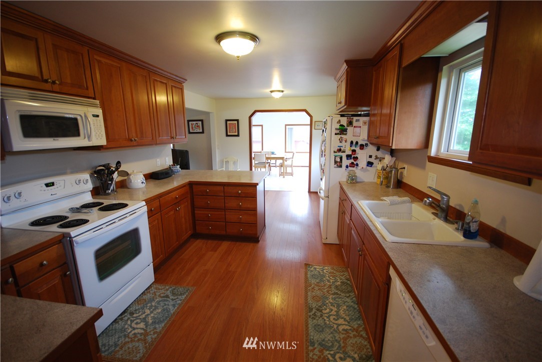 10404 Southeast 166th Street Renton, WA 98055 - Photo 12 of 29 a kitchen with stainless steel appliances granite countertop a sink stove and cabinets