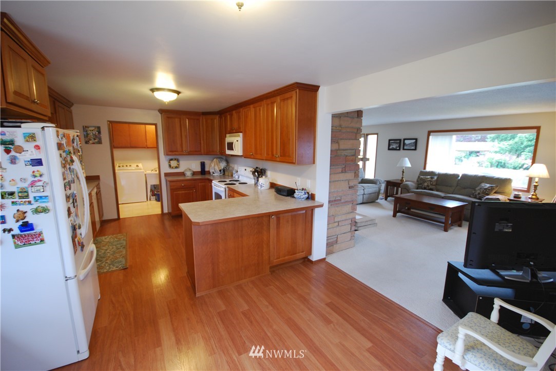 10404 Southeast 166th Street Renton, WA 98055 - Photo 13 of 29 a living room with furniture and a flat screen tv