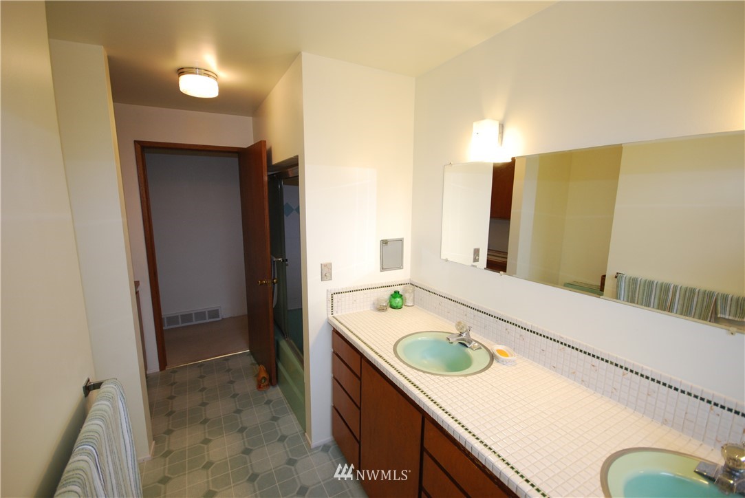 10404 Southeast 166th Street Renton, WA 98055 - Photo 17 of 29 a bathroom with a sink a bathtub and a shower