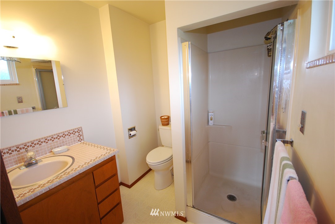 10404 Southeast 166th Street Renton, WA 98055 - Photo 18 of 29 a bathroom with a sink toilet and shower