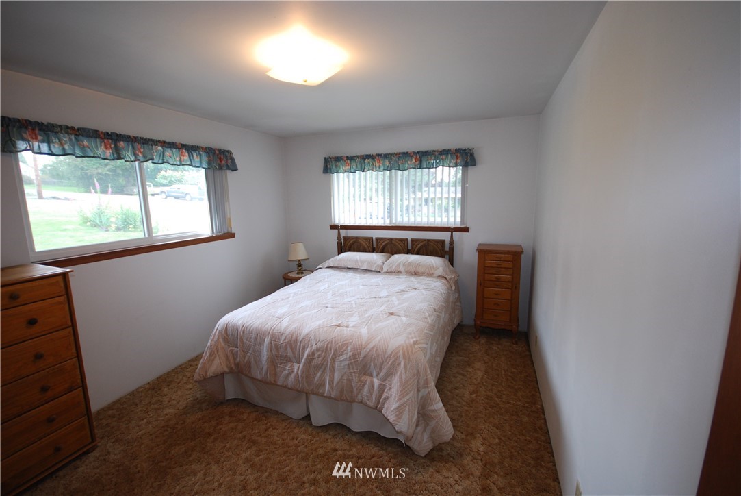 10404 Southeast 166th Street Renton, WA 98055 - Photo 19 of 29 a bed sitting in a bedroom next to a window