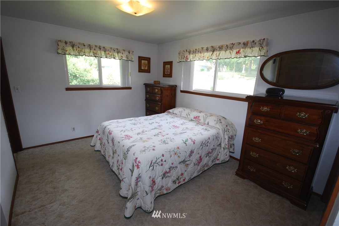 10404 Southeast 166th Street Renton, WA 98055 - Photo 20 of 29 a bedroom with a bed and a dresser next to a window