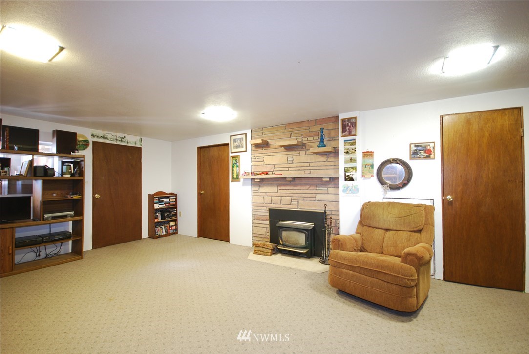10404 Southeast 166th Street Renton, WA 98055 - Photo 23 of 29 a living room with furniture and a fireplace