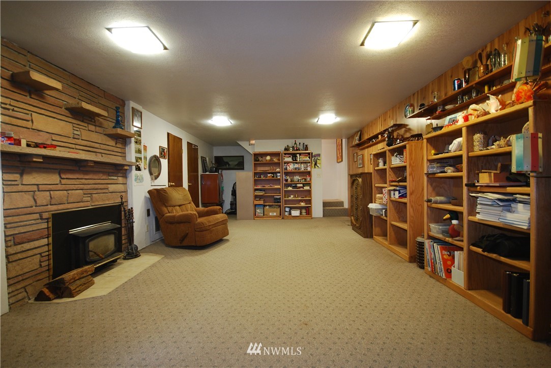 10404 Southeast 166th Street Renton, WA 98055 - Photo 24 of 29 a view of an empty room with furniture and a fireplace