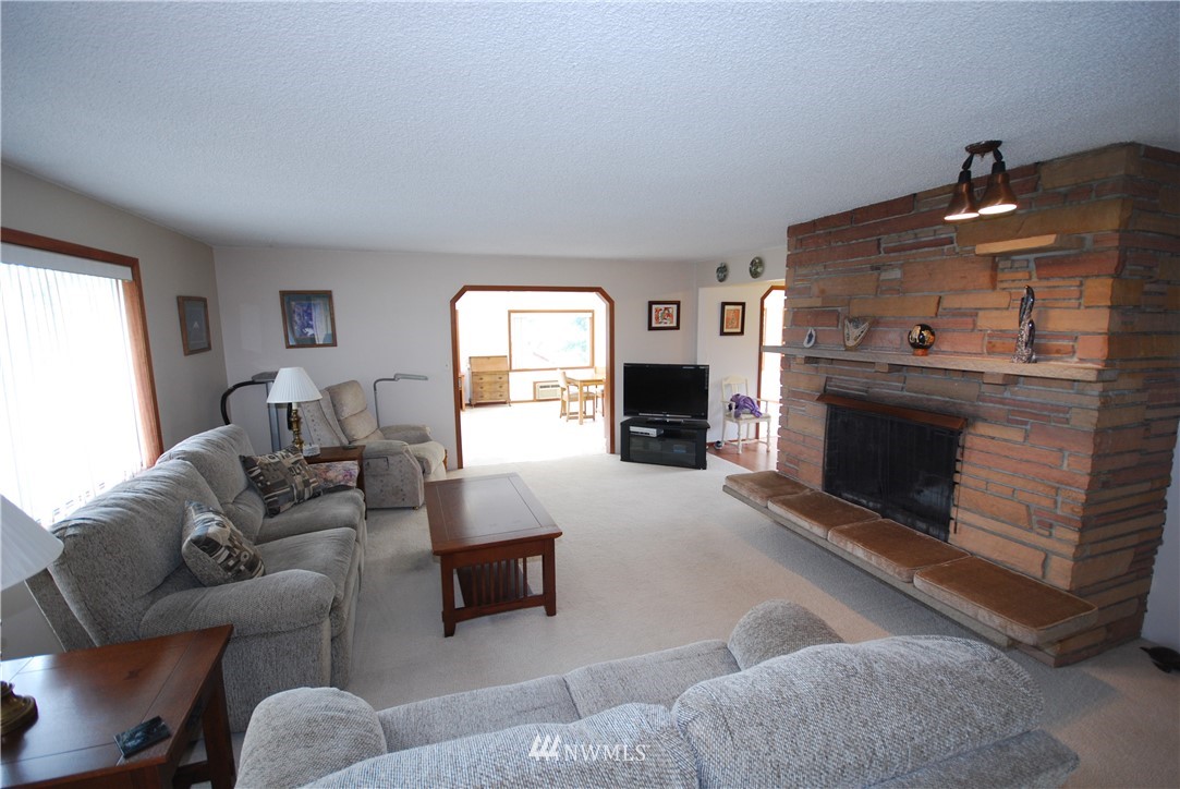 10404 Southeast 166th Street Renton, WA 98055 - Photo 5 of 29 a living room with furniture and a fireplace