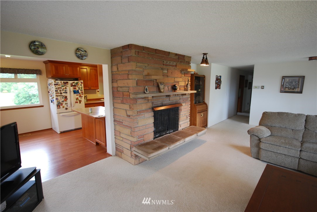 10404 Southeast 166th Street Renton, WA 98055 - Photo 6 of 29 a living room with furniture and a fireplace