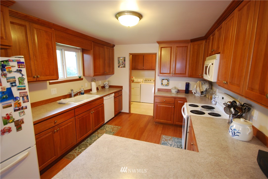 10404 Southeast 166th Street Renton, WA 98055 - Photo 10 of 29 a kitchen with a sink a stove and cabinets