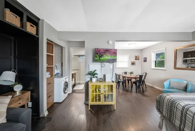 a living room with furniture and a wooden floor