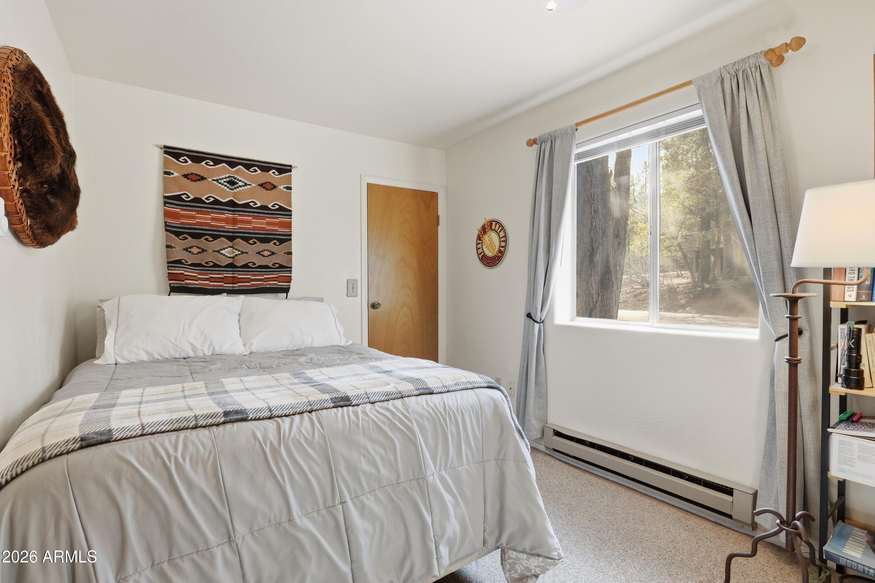 3715 Bloody Basin Road Pine, AZ 85544 - Photo 13 of 24 a bedroom with a bed and a window