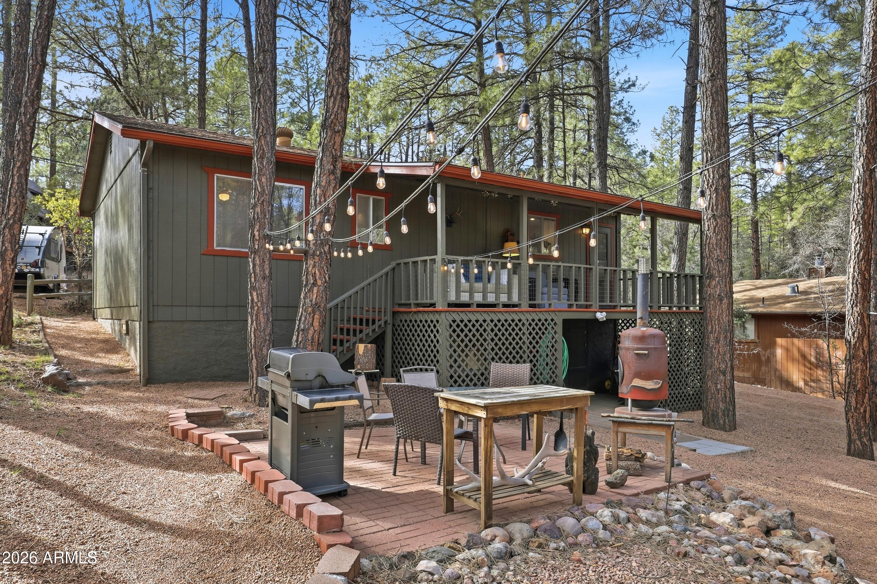 3715 Bloody Basin Road Pine, AZ 85544 - Photo 18 of 24 a view of a chairs and table in the patio in front of a house