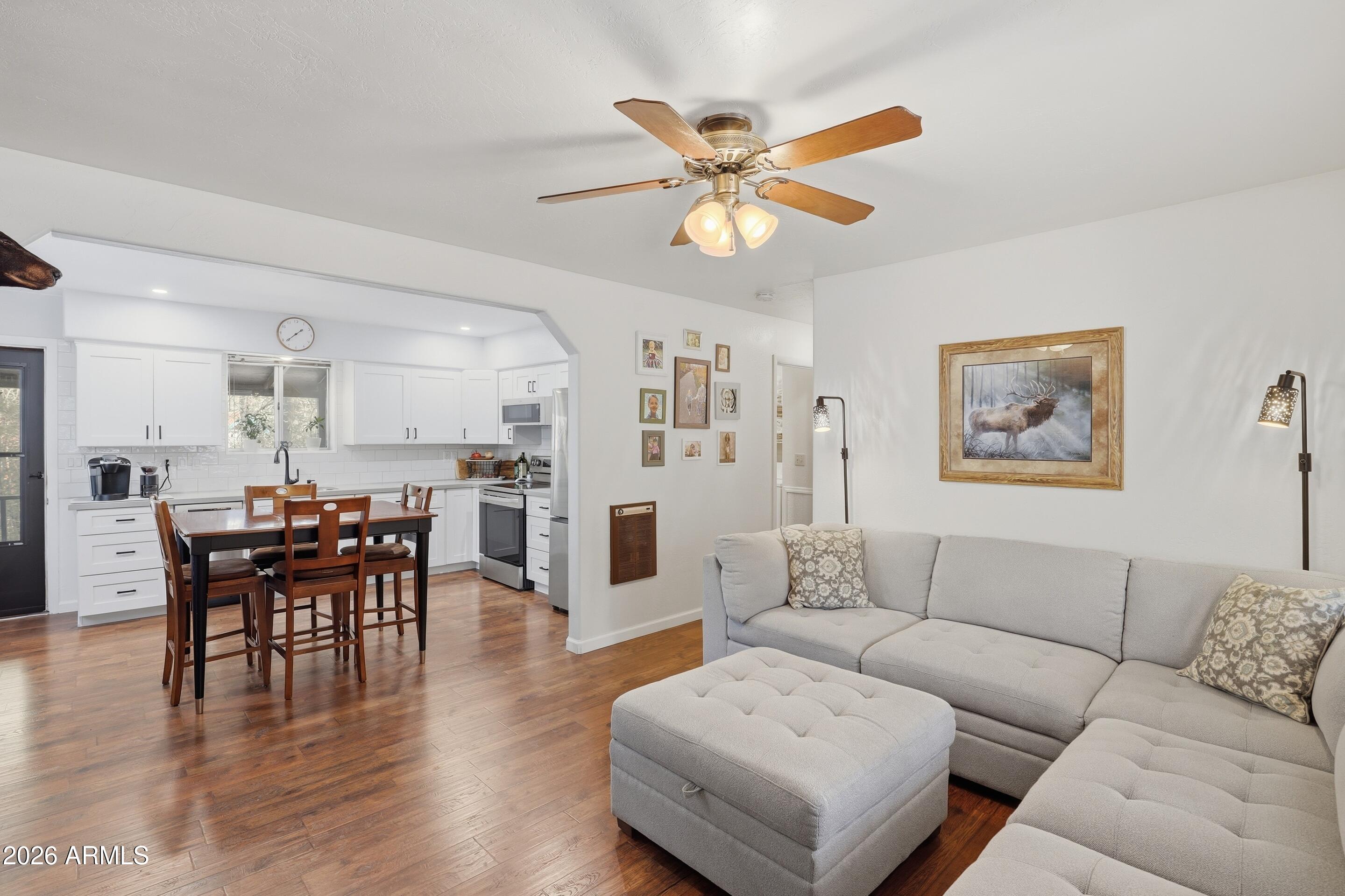3715 Bloody Basin Road Pine, AZ 85544 - Photo 5 of 24 a living room with furniture wooden floor and kitchen view