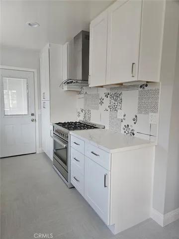 a kitchen with stainless steel appliances white cabinets and a sink
