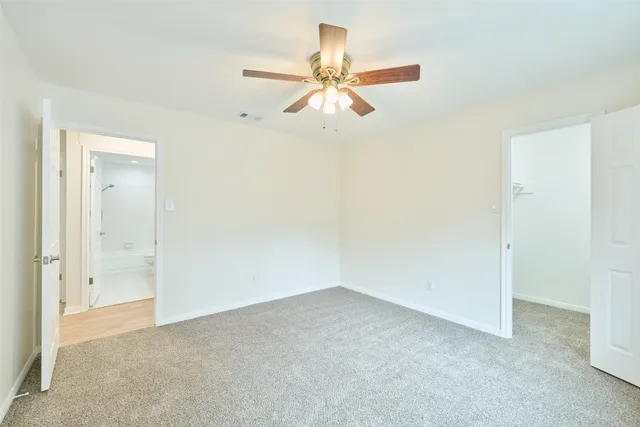 a front view of house with yard and trees in the background