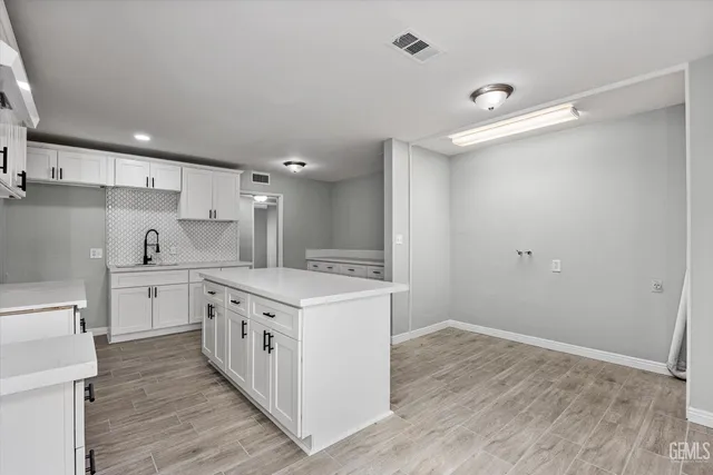 a kitchen with a stove a sink and a refrigerator