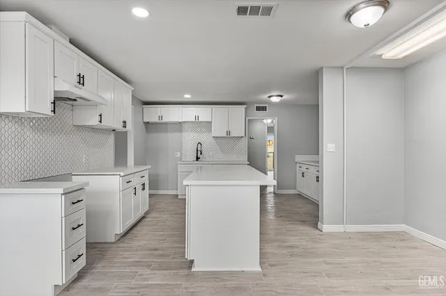 a kitchen with a stove a sink and a refrigerator