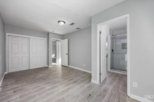 a view of an empty room with wooden floor