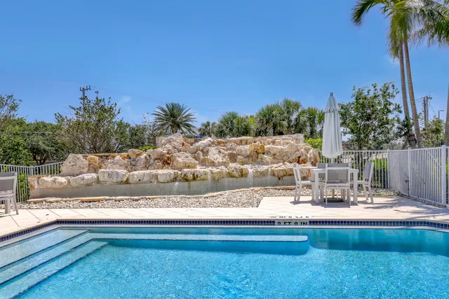 a view of swimming pool with a garden and outdoor seating