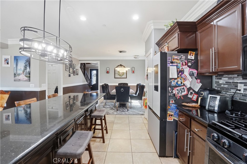 4415 Bethel Road Jurupa Valley, CA 92509 - Photo 22 of 65 a kitchen with stainless steel appliances granite countertop a lot of counter space and wooden floor