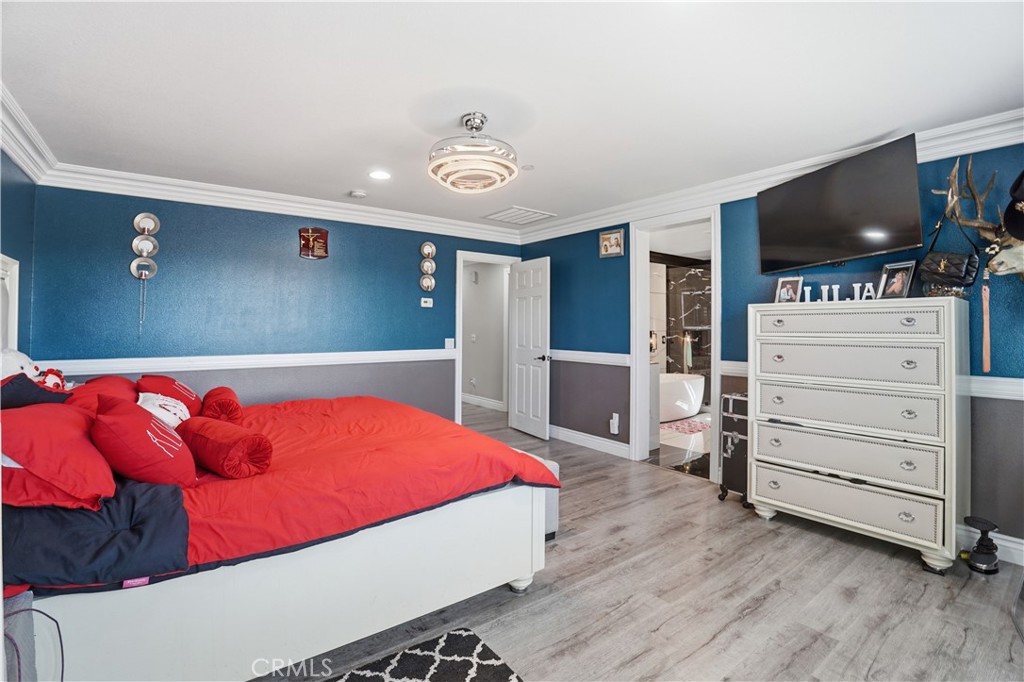 4415 Bethel Road Jurupa Valley, CA 92509 - Photo 29 of 65 a bedroom with a bed and flat screen tv