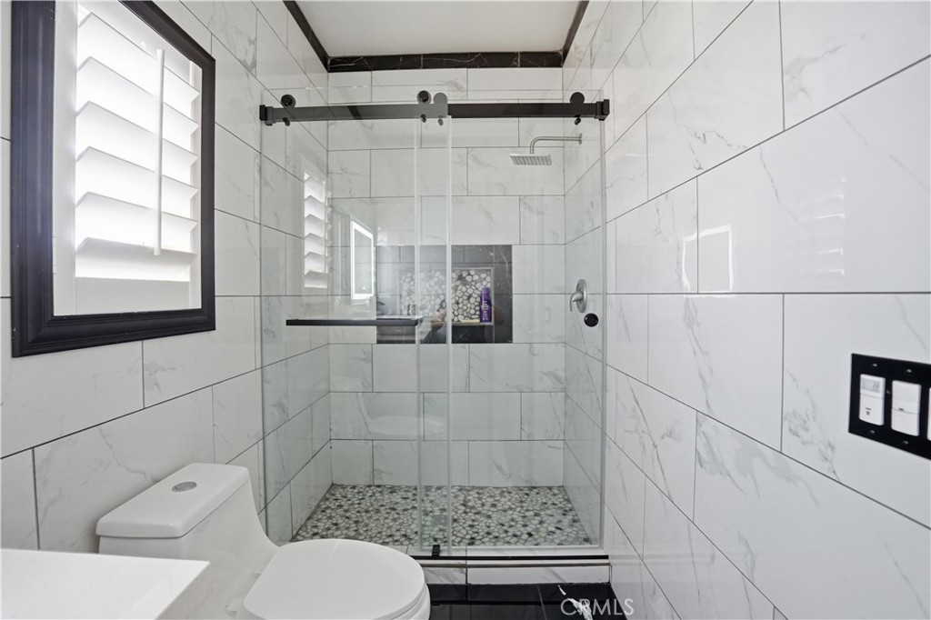 4415 Bethel Road Jurupa Valley, CA 92509 - Photo 34 of 65 a bathroom with a shower toilet and sink
