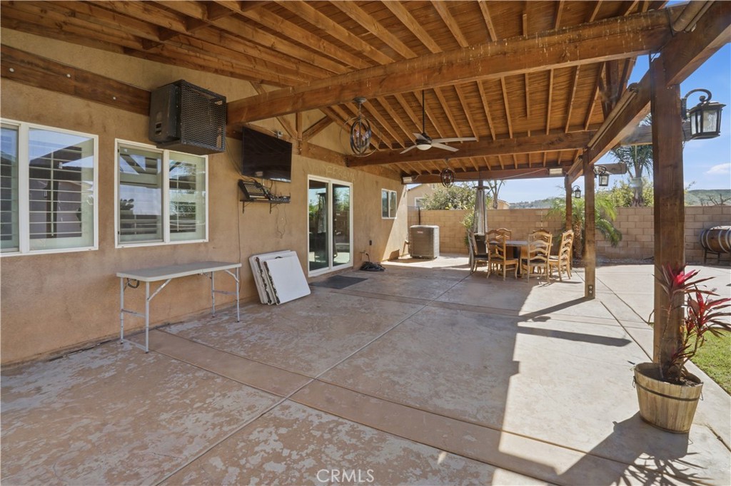 4415 Bethel Road Jurupa Valley, CA 92509 - Photo 49 of 65 a view of a porch with furniture and floor to ceiling window