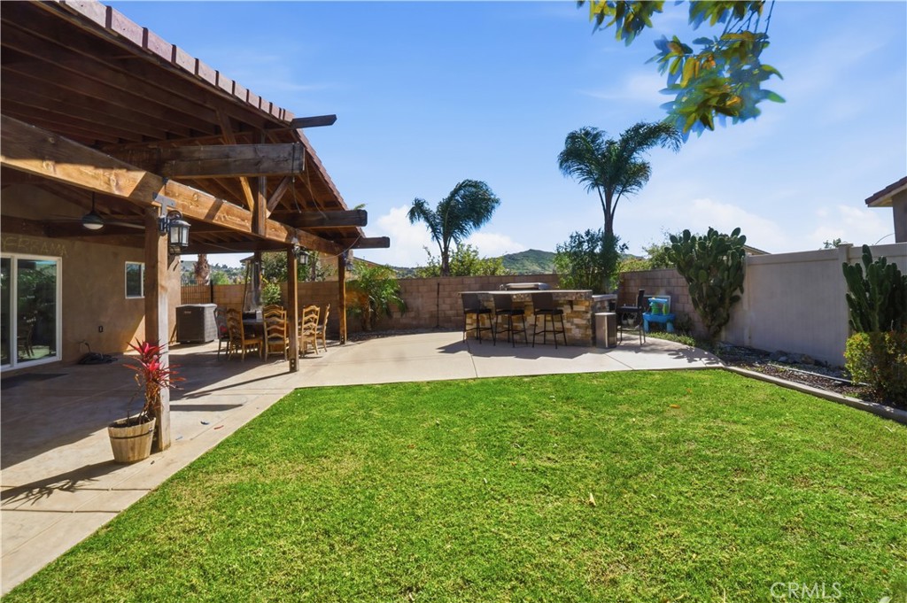 4415 Bethel Road Jurupa Valley, CA 92509 - Photo 52 of 65 a view of a patio with table and chairs potted plants and palm tree