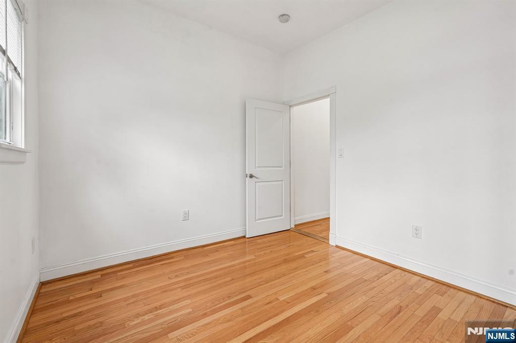 90 A Hackensack Plank Road Weehawken, NJ 07086 - Photo 28 of 40 a view of an empty room with wooden floor and a window