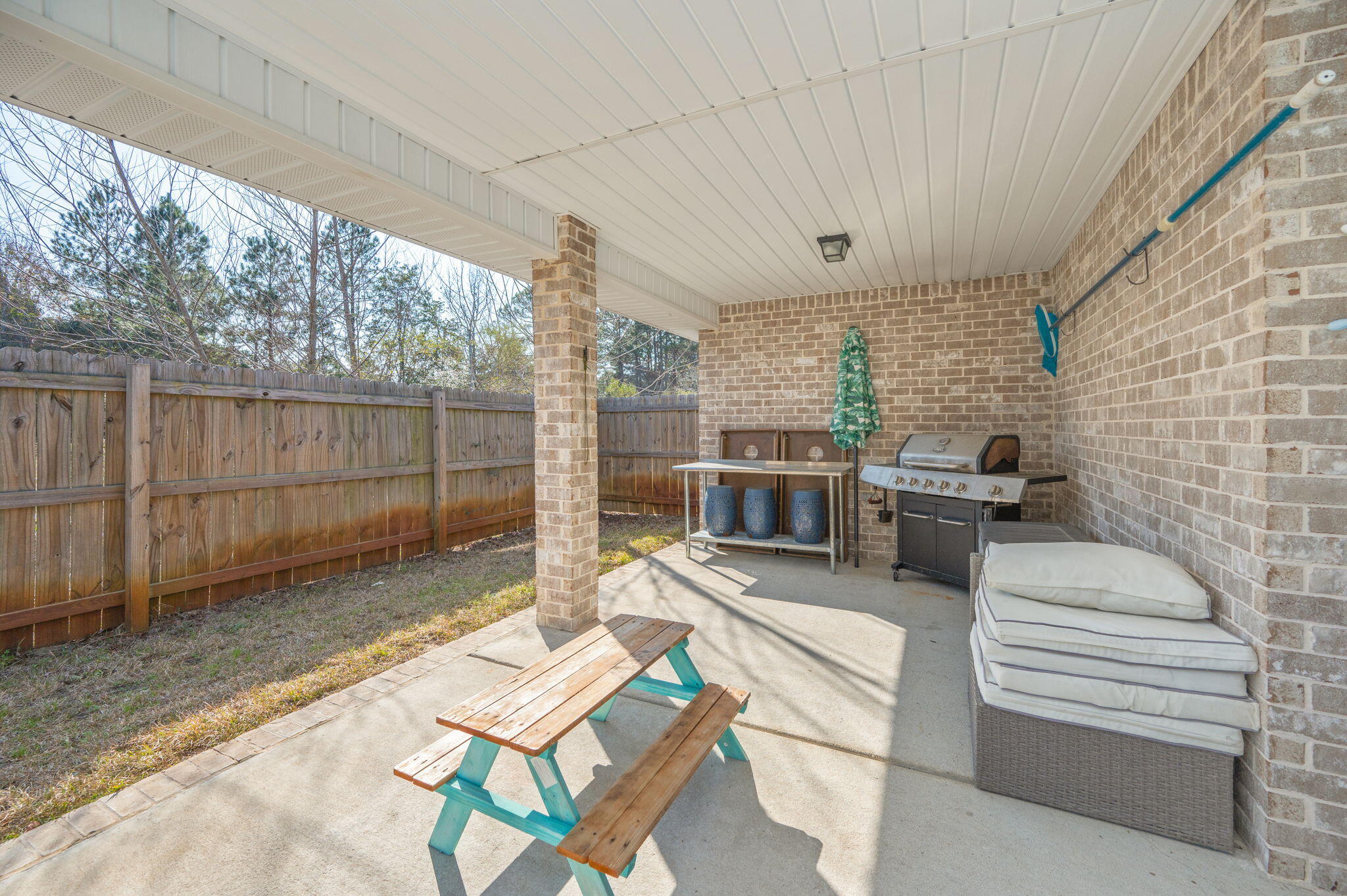 2714 Ola Broxson Road Navarre, FL 32566 - Photo 11 of 52 a view of a patio with a chairs and table in the patio