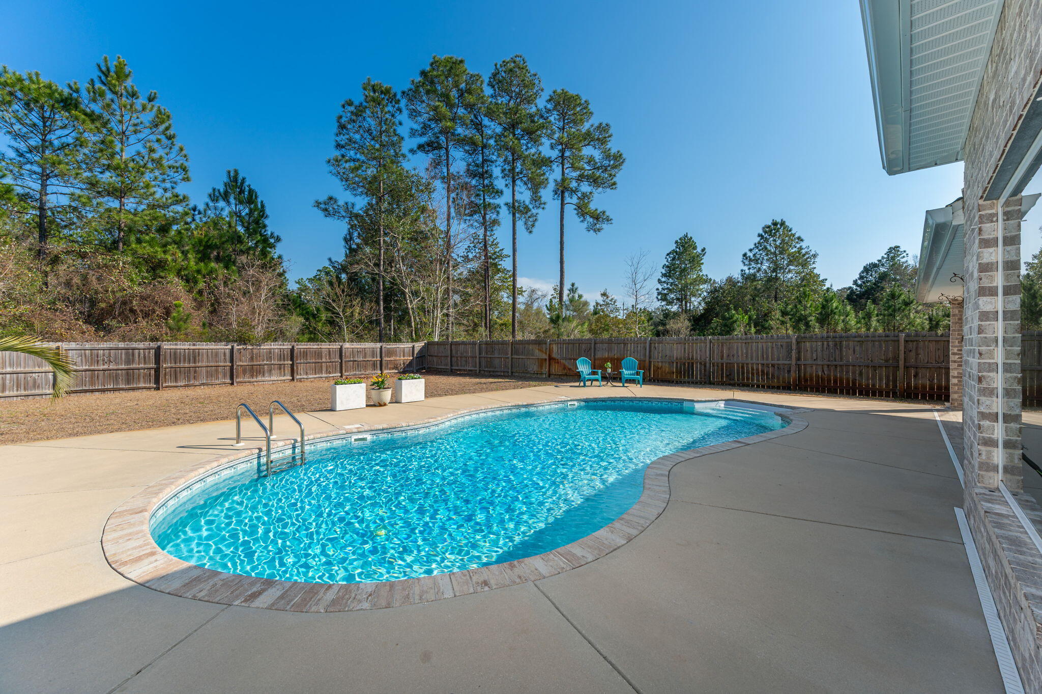 2714 Ola Broxson Road Navarre, FL 32566 - Photo 13 of 52 a view of a swimming pool with a outdoor seating