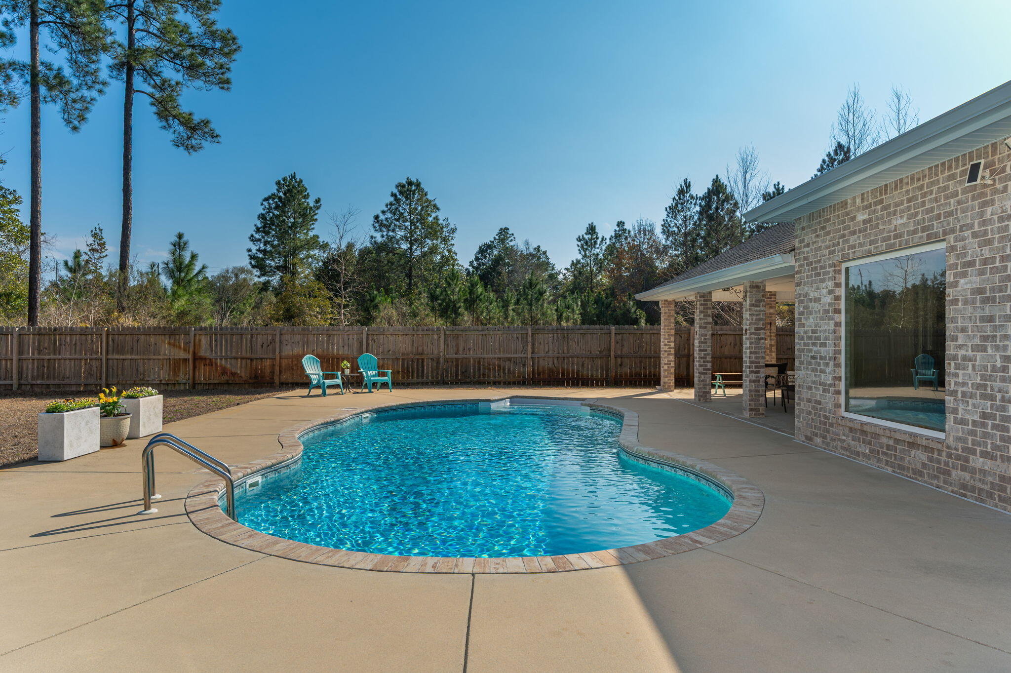 2714 Ola Broxson Road Navarre, FL 32566 - Photo 14 of 52 a view of a swimming pool with a patio