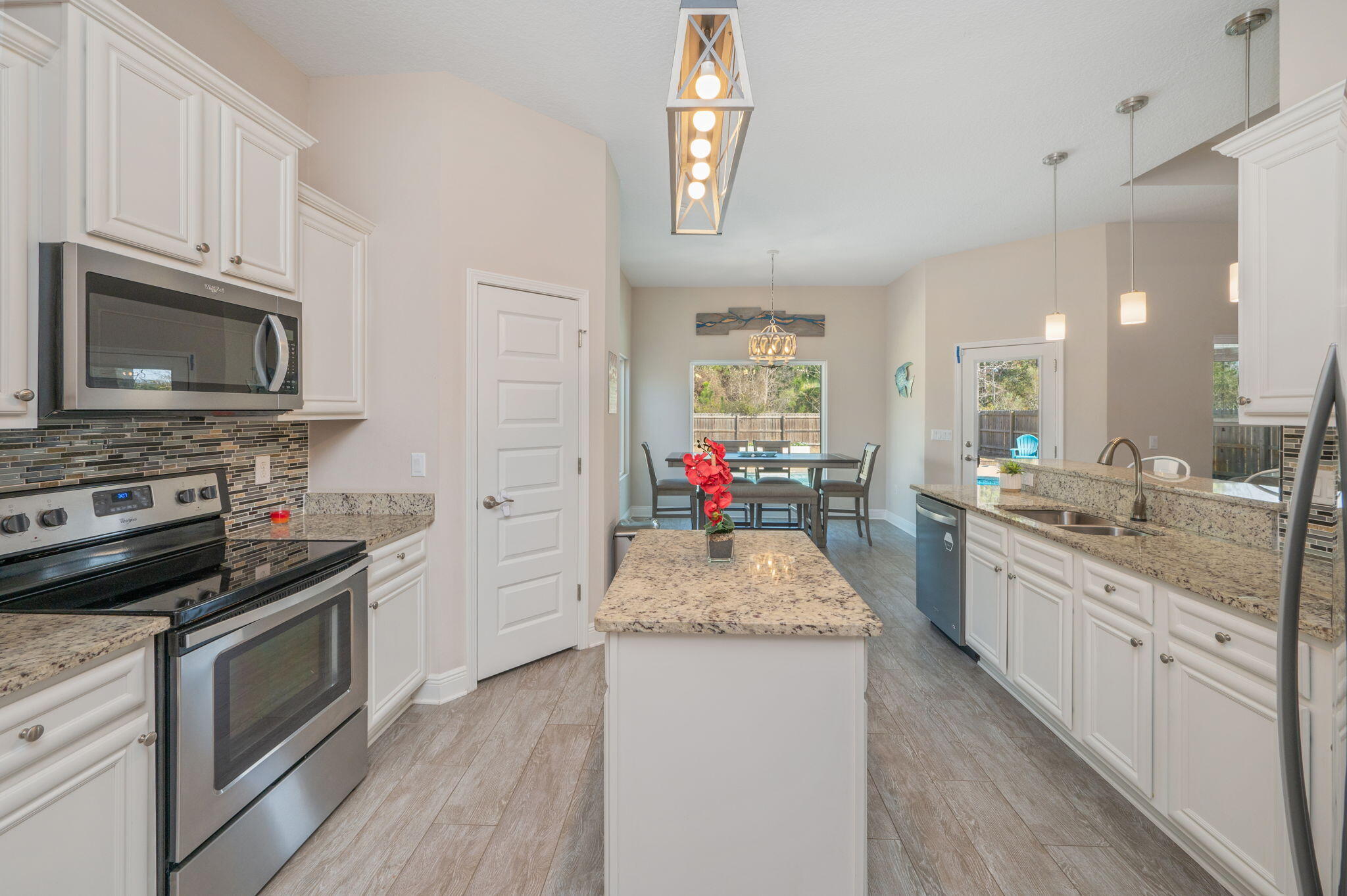 2714 Ola Broxson Road Navarre, FL 32566 - Photo 19 of 52 a kitchen with granite countertop kitchen island wooden cabinets granite counter tops and a stove
