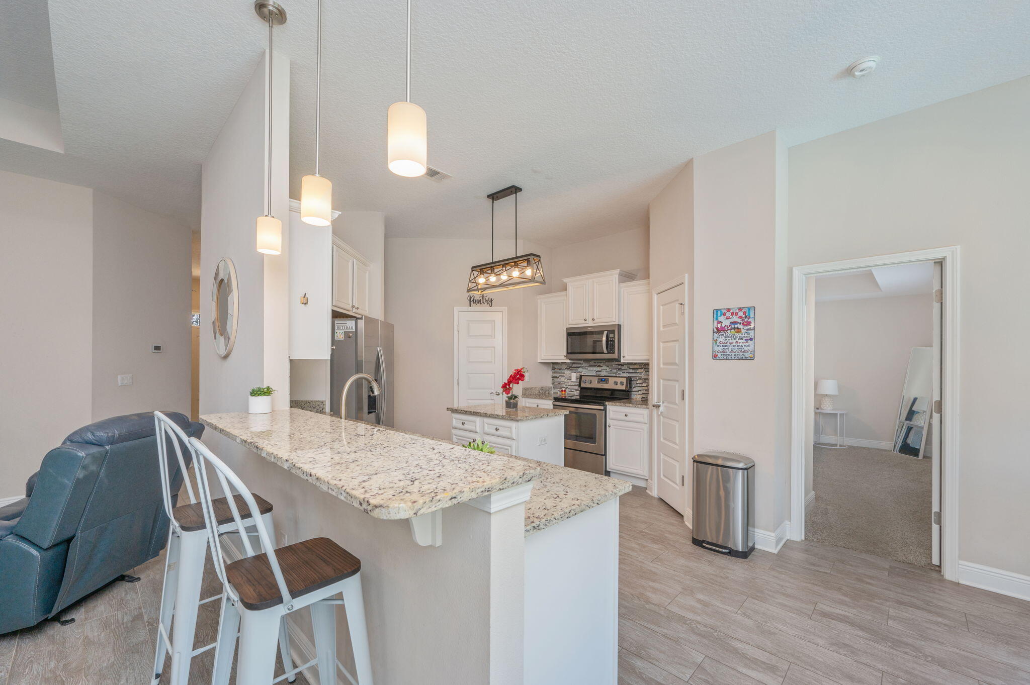 2714 Ola Broxson Road Navarre, FL 32566 - Photo 22 of 52 a kitchen with kitchen island and stainless steel appliances