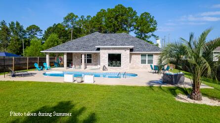 2714 Ola Broxson Road Navarre, FL 32566 - Photo 3 of 52 a house view with a sitting space and garden
