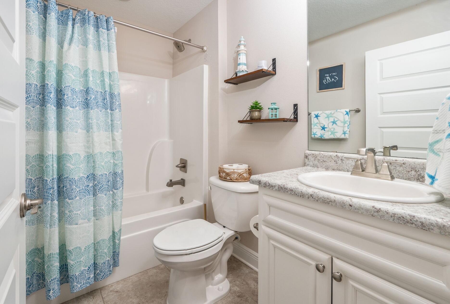 2714 Ola Broxson Road Navarre, FL 32566 - Photo 44 of 52 a bathroom with a granite countertop sink toilet and shower