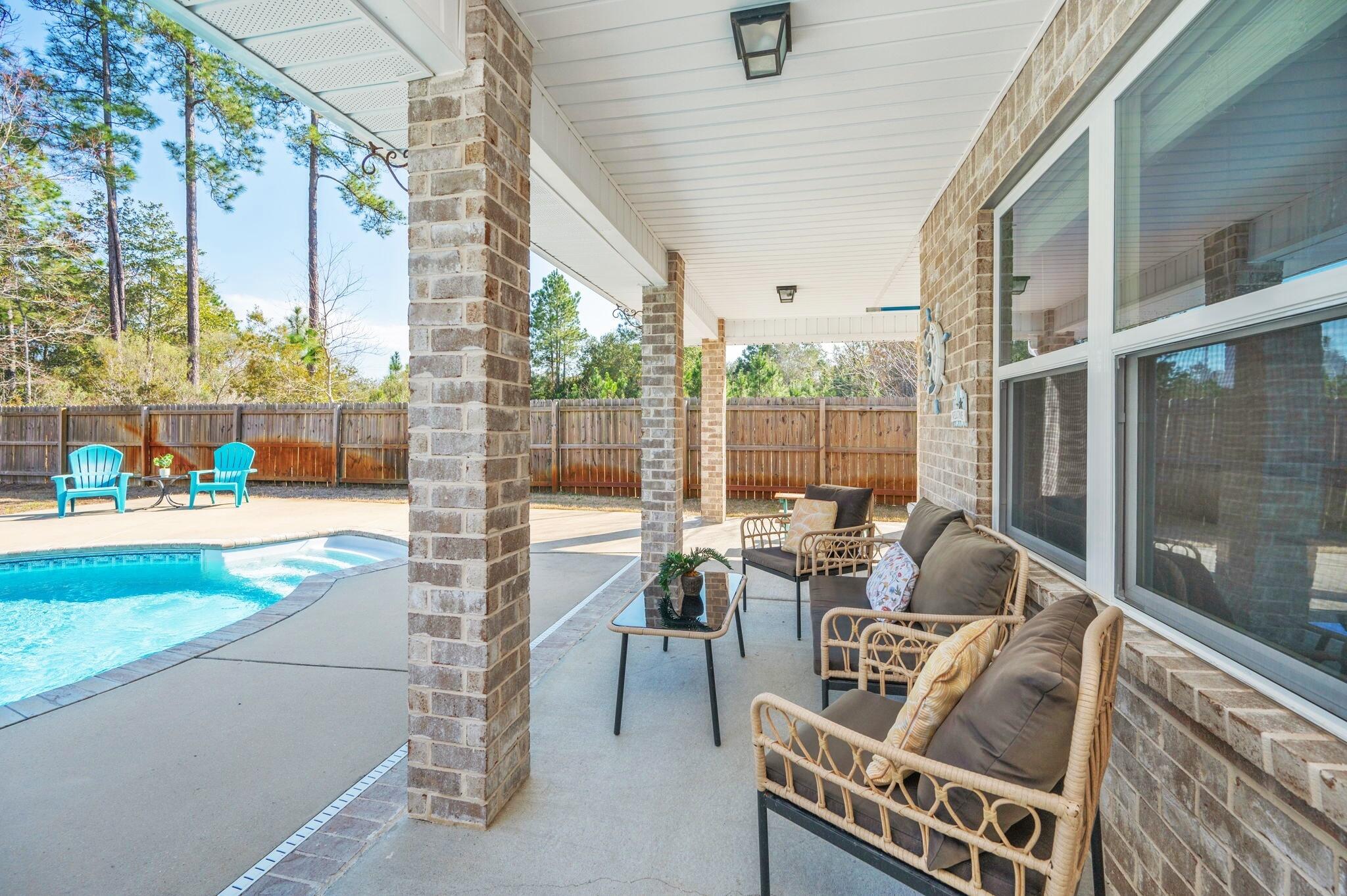 2714 Ola Broxson Road Navarre, FL 32566 - Photo 10 of 52 a living room with patio furniture and a garden