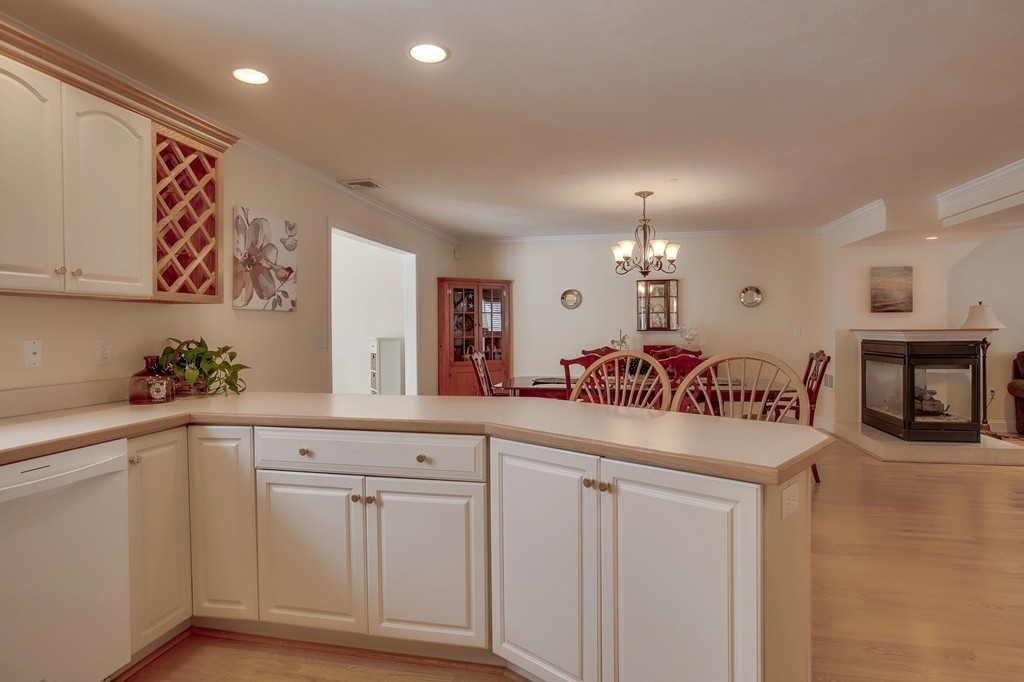 216 Rangeway Road, Unit 192 Billerica, MA 01862 - Photo 11 of 20 a living room with white cabinets and chandelier