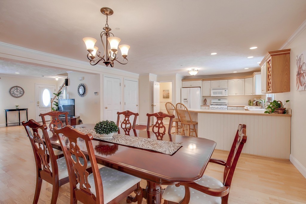 216 Rangeway Road, Unit 192 Billerica, MA 01862 - Photo 12 of 20 a view of a dining room with furniture a chandelier and wooden floor
