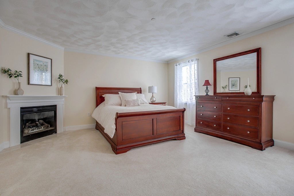 216 Rangeway Road, Unit 192 Billerica, MA 01862 - Photo 15 of 20 a bedroom with a bed and a fireplace