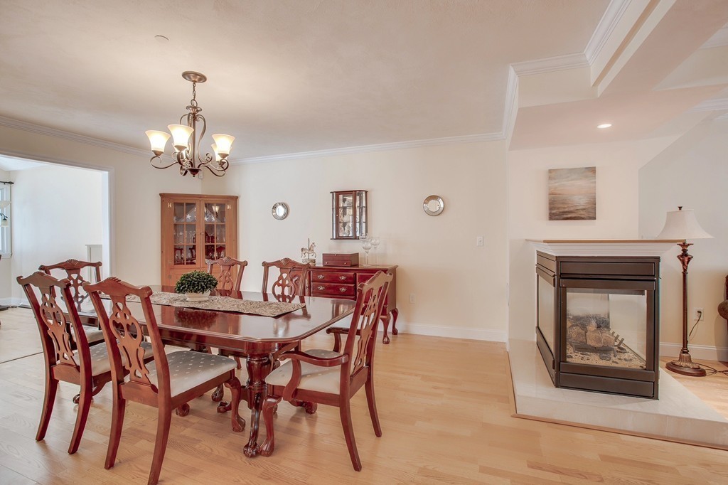 216 Rangeway Road, Unit 192 Billerica, MA 01862 - Photo 8 of 20 a view of a dining room with furniture wooden floor and chandelier