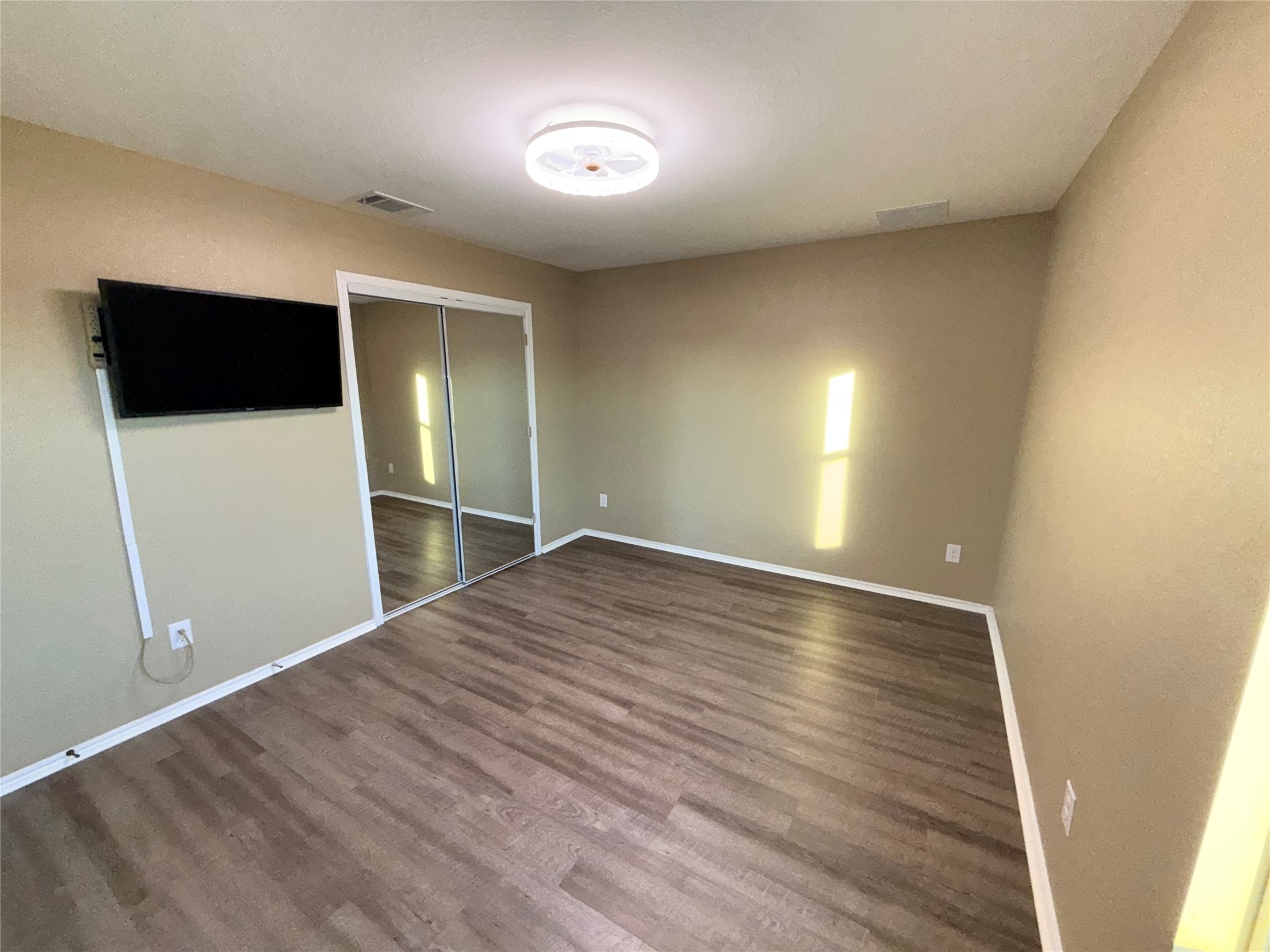 228 Texas Angel Way Jarrell, TX 76537 - Photo 11 of 33 a view of empty room with wooden floor