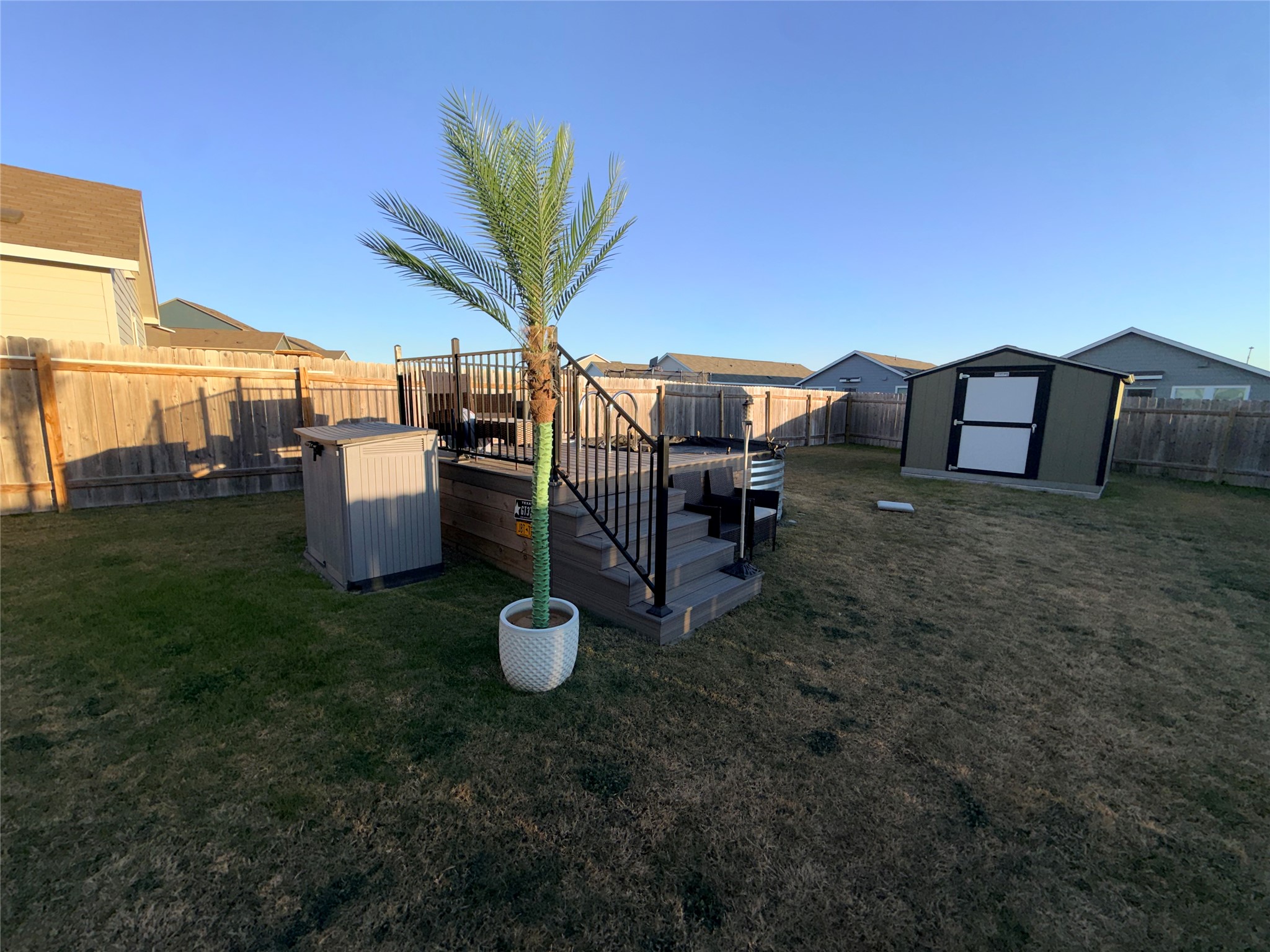 228 Texas Angel Way Jarrell, TX 76537 - Photo 29 of 33 a view of a backyard with table and chairs couches under an umbrella with wooden fence