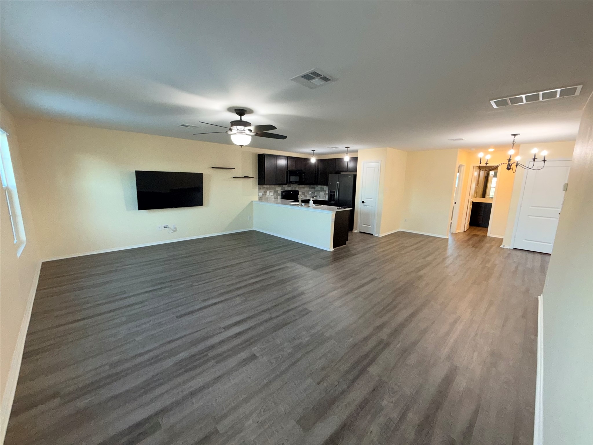 228 Texas Angel Way Jarrell, TX 76537 - Photo 4 of 33 a view of a big room with wooden floor and a fireplace