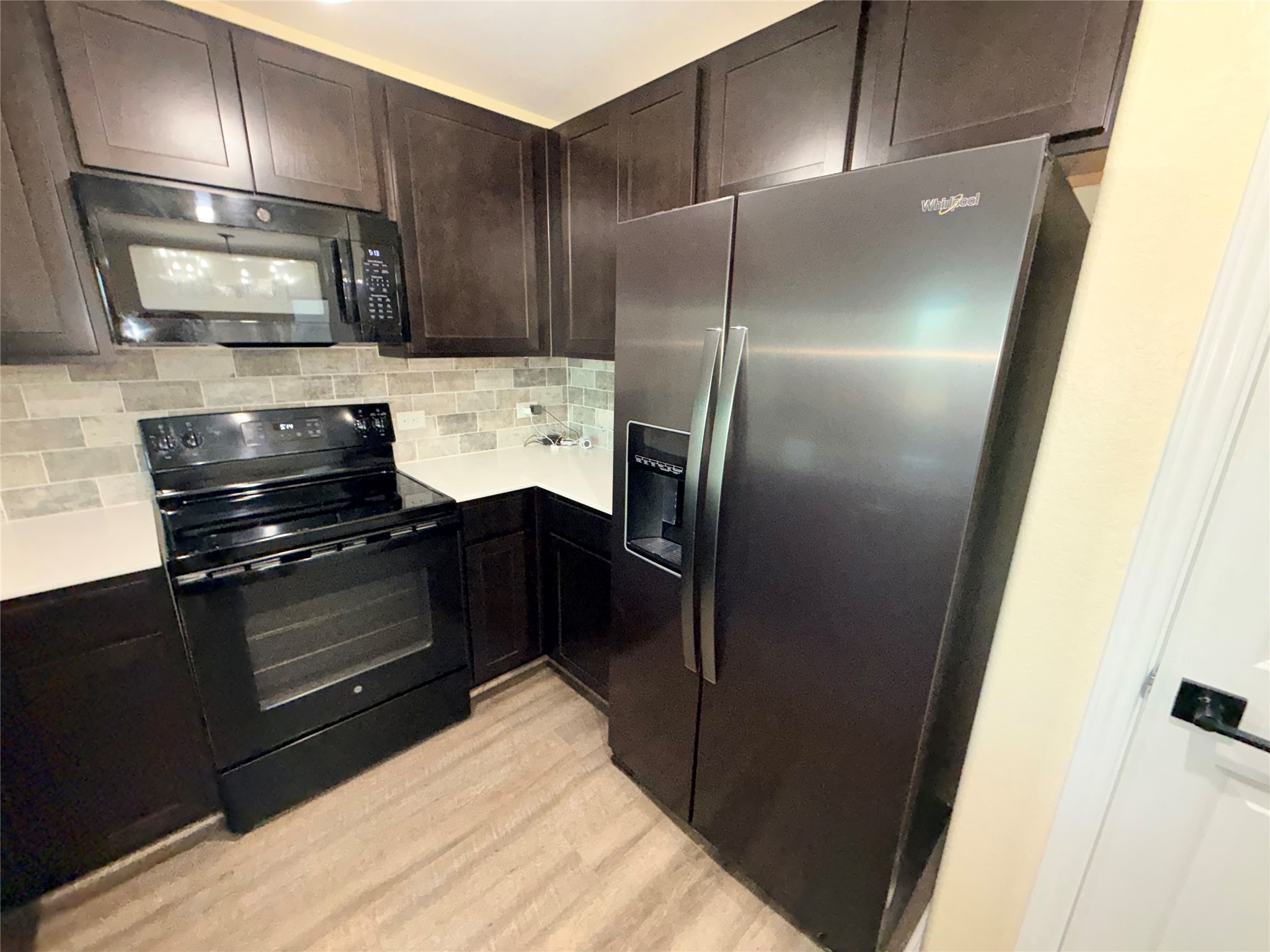 228 Texas Angel Way Jarrell, TX 76537 - Photo 6 of 33 a kitchen with a refrigerator and a sink